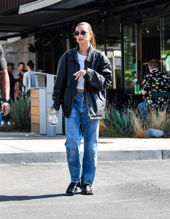 EXCLUSIVE: Hailey Bieber Was Spotted Looking Stylishly Fashionable In Sunglasses, Leather Jacket, And Jeans After A Quick Smoothie Photoshoot At Erewhon For Erewhon In Los Angeles, CA. While Saying By To Friends And Crew, The Model & Rocker Pete Wentz Unknowingly Ran Into Each other Without Noticing Each other. 18 May 2022 Pictured: Hailey Bieber Was Spotted Looking Stylishly Fashionable In Sunglasses, Leather Jacket, And Jeans After A Quick Smoothie Photoshoot At Erewhon For Erewhon In Los Angeles, CA. While Saying By To Friends And Crew, The Model & Rocker Pete Wentz Unknowingly Ran Into Each other Without Noticing Each other. Photo credit: @CelebCandidly / MEGA TheMegaAgency.com +1 888 505 6342 (Mega Agency TagID: MEGA858951_002.jpg) [Photo via Mega Agency]