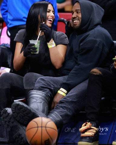 Rapper Kanye West and girlfriend Chaney Jones attend a game between the Miami Heat and the Minnesota Timberwolves at FTX Arena Celebrities at Miami Heat v Minnesota Timberwolves, Basketball at FTX Arena, Miami, Florida, USA - 12 Mar 2022