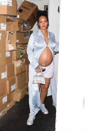 Los Angeles, CA - Rihanna shows off her burgeoning baby bump as she is seen leaving Wally's restaurant after dining in Beverly Hills.  The 34-year-old singer wears a sky blue silk dressing gown, a sparkling Balenciaga handbag with matching glitter Nike sneakers and white boxer shorts.  Pictured: Rihanna BACKGRID USA 9 APRIL 2022 BYLINE MUST READ: TPG / BACKGRID USA: +1 310 798 9111 / usasales@backgrid.com UK: +44 208 344 2007 / uksales@backgrid.com *UK Clients - Images containing children, please Pixelate Face before posting*