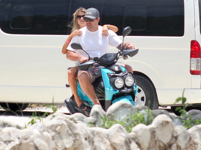 Christina Haack and Joshua Hall ride a scooter on vacation