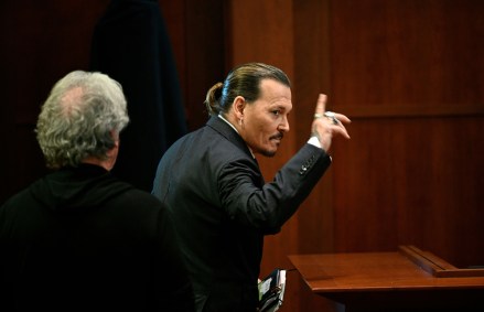 Actor Johnny Depp gestures as he walks out of the courtroom during a break at the Fairfax County Circuit Courthouse in Fairfax, Va., . Actor Johnny Depp sued his ex-wife Amber Heard for libel in Fairfax County Circuit Court after she wrote an op-ed piece in The Washington Post in 2018 referring to herself as a "public figure representing domestic abuse
Depp Heard Lawsuit, Fairfax, United States - 17 May 2022
