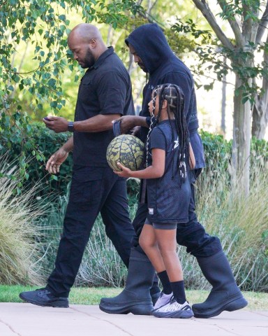 Los Angeles, CA  - *EXCLUSIVE* - Kanye West meets up with daughter North prior to her basketball game in Los Angeles. North dribbles a basketball as she walks next to dad who wears an all-black outfit with his signature rubber boots.  Pictured: Kanye West, North West   BACKGRID USA 29 JULY 2022   USA: +1 310 798 9111 / usasales@backgrid.com  UK: +44 208 344 2007 / uksales@backgrid.com  *UK Clients - Pictures Containing Children Please Pixelate Face Prior To Publication*