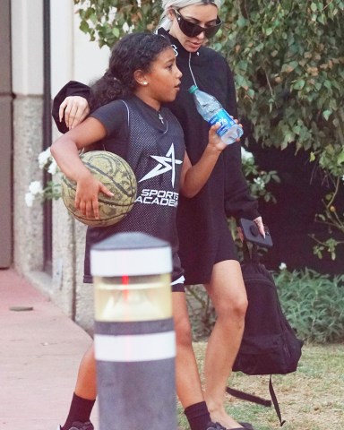 Calabasas, CA  - Kim Kardashian is seen for the first time in Calabasas since Ray J accused her and mother Kris Jenner of masterminding the sale of their infamous sex tape. Kim was seen with her assistant Tracy as they attended a kid's basketball game. The reality star was dressed casually in a short black dress that showed off the discoloration in one of her legs. Kim suffers from psoriasis, a chronic condition that can flare up as a result of stress. Kim's sex tape partner, Ray J went off on Kim and Kris this weekend after the momager took a polygraph test on James Corden's show denying she was involved in the release of the tape. Ray J claims there was 2 different sex tapes and claims Kris selected the one where Kim looked the best. He also claimed Kim, in her own handwriting,  wrote out the description of the tapes in the  contract with Vivid which later released the tape. TMZ has reported that the couple were sent an email "from Vivid Entertainment honcho Steve Hirsch dated May 1, 2007, in which he informs Kim the tape made $1,424,636.63 in revenue, including the majority, $1,255,578.50, coming from DVD sales.''Pictured: Kim KardashianBACKGRID USA 13 SEPTEMBER 2022 BYLINE MUST READ: Jvshvisions / BACKGRIDUSA: +1 310 798 9111 / usasales@backgrid.comUK: +44 208 344 2007 / uksales@backgrid.com*UK Clients - Pictures Containing ChildrenPlease Pixelate Face Prior To Publication*