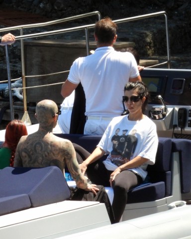 EXCLUSIVE: Kourtney Kardashian and Travis Barker seen in a boat, the day before their Italian wedding in Portofino. 20 May 2022 Pictured: Kourtney Kardashian, Travis Barker. Photo credit: MEGA TheMegaAgency.com +1 888 505 6342 (Mega Agency TagID: MEGA859696_015.jpg) [Photo via Mega Agency]