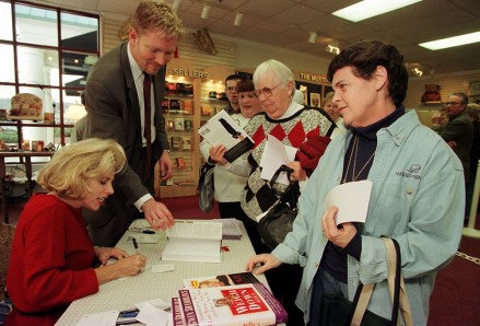 KRT RELIGION STORY SLUGGED: GODDIET KRT PHOTOGRAPH BY BARBARA JOHNSTON/PHILADELPHIA INQUIRER (KRT115- January 19) Gwen Shamblin autographs her book "Rise Above" for Shirley Kaylor (right) as Kaylor's friend, Elaine Sweigart, waits.  Rob Birkhead assists Shamblin.  (PH) PL KD 2000 (Horiz) (lde) Newscom/(Mega Agency TagID: krtphotos020408.jpg) [Photo via Mega Agency]