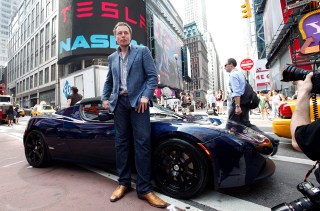 Elon Musk Elon Musk, CEO of Tesla Motors, poses with a Tesla car in front of Nasdaq following the electric automaker's initial public offering, Tuesday, June, 29, 2010, in New York. The company plans to trade on the Nasdaq stock exchange under the ticker "TSLA
Tesla Motors IPO, New York, USA
