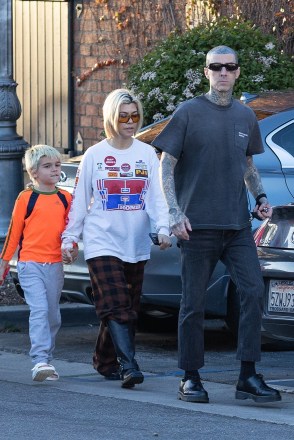 Calabasas, CA - *EXCLUSIVE* - Reality TV star Kourtney Kardashian sports a casual look during an early dinner with her son Reign and her husband Travis Barker at his Crossroads Kitchen restaurant. The vegan restaurant located in Calabasas has been a hit among the city's foodies and its plant-based cuisine is well known in the vegan community. The couple was seen holding hands as they arrived at the restaurant, and their casual conversation the outfits complemented each other perfectly.Pictured: Kourtney Kardashian, Travis Barker BACKGRID USA APRIL 2, 2023 BYLINE MUST READ: LAGOSSIPTV / BACKGRID USA: +1 310 798 9111 / usasales@backgrid.com UK: +44 208 344 2007 / uksales@backgrid.com *UK customers - Photos containing children, please pixelate the face before publishing*