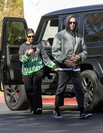 CALABASASS, CA - *EXCLUSIVE* - Kourtney Kardashian and husband Travis Barker refuse to miss a moment when they're not trapped in an embrace. Courtney gets out of the car and takes a picture of the skeleton that Travis is loading onto the truck. PHOTOS: Kourtney Kardashian, Travis Barker BACKGRID USA 26 October 2022 USA: +1 310 798 9111 / usasales@backgrid.com UK: +44 208 344 2007 / uksales@backgrid.com Publications*