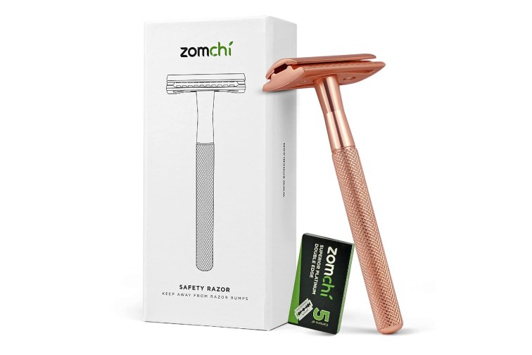 zomchi double edge safety razor in rose gold leaning against its package