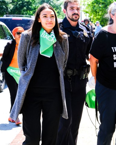 Democrats Alexandria Ocasio-Cortez, Ilhan Omar and other Democratic members of Congress were arrested outside of the Supreme Court on Tuesday protesting the overturning of Roe v. Wade. Squad Members appeared in good spirits taking selfies and dancing to music while being detained by police.Rep. Alexandria Ocasio-Cortez pictured.
Democratic Congress members protest Supreme Court abortion ruling in DC, Washington, USA - 19 Jul 2022