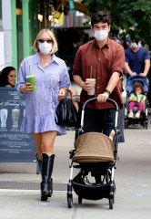 Chloe Sevigny looks super stylish in a mini skirt dress with knee high boots while on a stroll with partner Sinisa Mackovic and their baby Vanja during a stop to buy some beverages from "Juice Press" in Manhattan's Soho area. 27 Sep 2020 Pictured: Chloe Sevigny and Sinisa Mackovic. Photo credit: LRNYC / MEGA TheMegaAgency.com +1 888 505 6342 (Mega Agency TagID: MEGA703755_001.jpg) [Photo via Mega Agency]