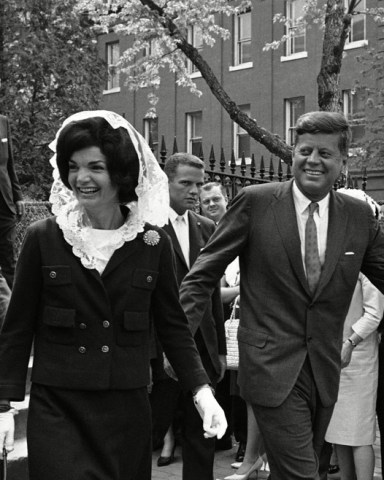 John F. Kennedy, Jacqueline Kennedy President John F. Kennedy and first lady Jacqueline Kennedy leave Holy Trinity Catholic Church in Georgetown, Washington, after attending Mass. Mrs. Kennedy wears a while mantilla to cover her head
JFK And Jackie, Washington, USA