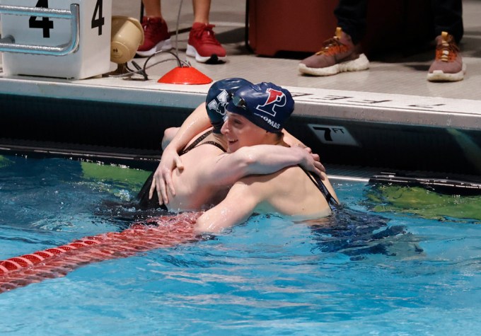 Lia Thomas hugs a fellow swimmer