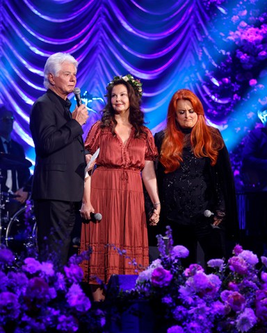 NASHVILLE, TENNESSEE - MAY 15: (L-R) Larry Strickland, Ashley Judd, and Wynonna Judd speak onstage during CMT and Sandbox Live's "Naomi Judd: A River Of Time Celebration" at Ryman Auditorium on May 15, 2022 in Nashville, Tennessee. (Photo by Katie Kauss/Getty Images for CMT)