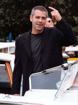 CLOONEY American actor George Clooney reacts to fans as he arrives at the Lido for the Venice Film Festival . Clooney stars in the Steven Soderbergh film "Out Of Sight", which will be presented Wednesday
ITALY VENICE FESTIVAL, VENICE, Italy