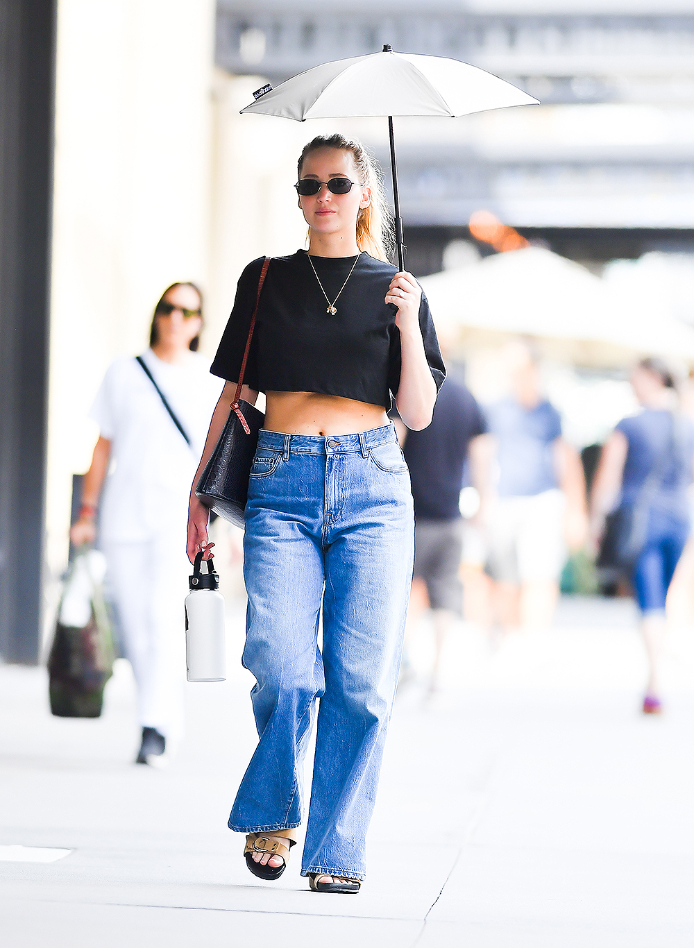 Jennifer Lawrence Goes For A Coffee Run While Holding An Umbrella In New York City