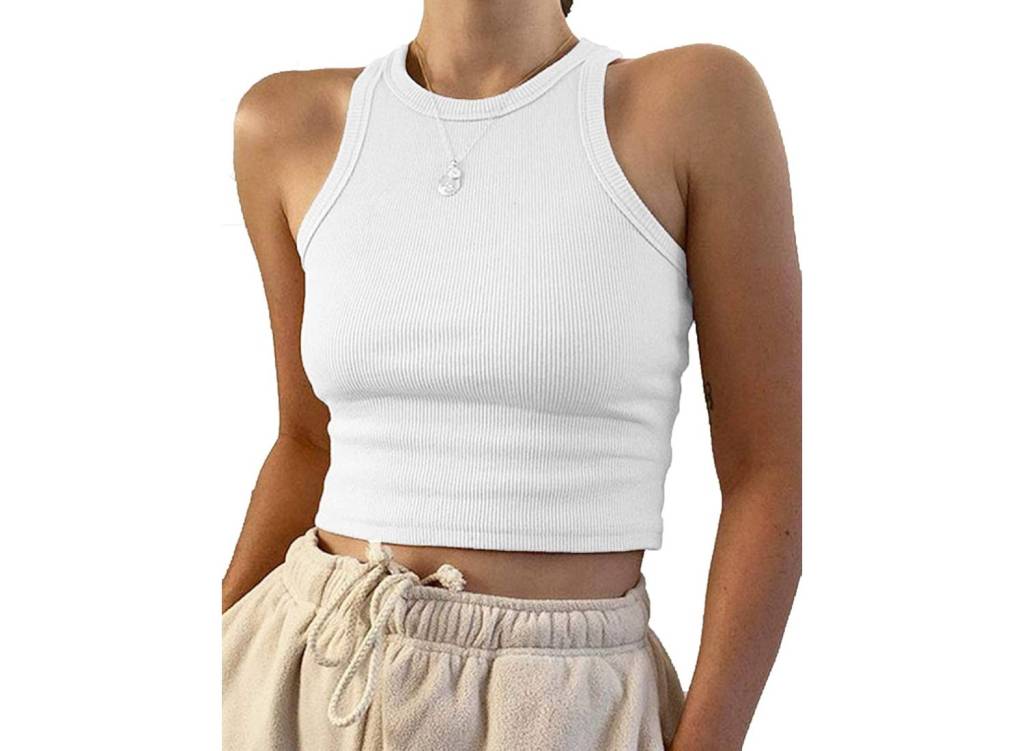 Woman model wearing a white, ribbed cropped tank top with beige pants