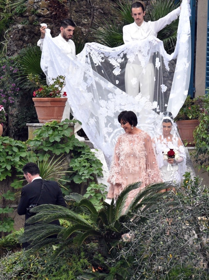 Kourtney Kardashian is seen walking down the aisle with her long veil