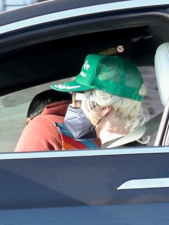 Malibu, CA  - *EXCLUSIVE*  - Lady Gaga and boyfriend Michael Polansky pick up his car that was parked on PCH in Malibu. The pop star wore a green cap over her hair which appeared to have been chopped down just beneath her ear  with a strand of hair left long to her shoulders.Pictured: Lady Gaga, Michael PolanskyBACKGRID USA 10 MAY 2022 BYLINE MUST READ: RMBI / BACKGRIDUSA: +1 310 798 9111 / usasales@backgrid.comUK: +44 208 344 2007 / uksales@backgrid.com*UK Clients - Pictures Containing ChildrenPlease Pixelate Face Prior To Publication*