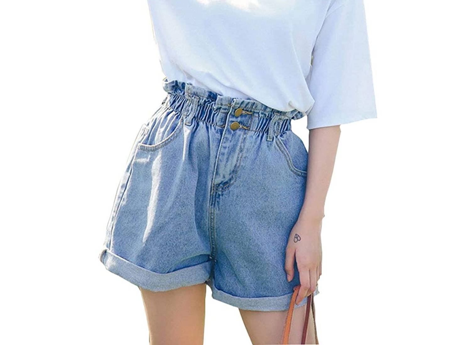 A woman wearing a T-shirt and a pair of stretch high-waisted denim shorts