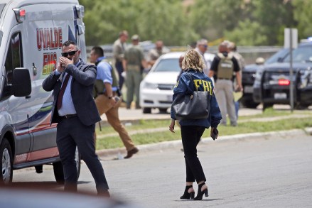Law enforcement personnel, including the FBI, gather near Robb Elementary School following a shooting, in Uvalde, Texas Texas School Shooting, Uvalde, United States - May 24, 2022