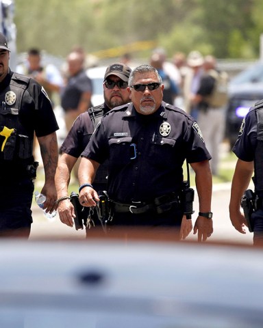 Police walk near Robb Elementary School following a shooting, in Uvalde, Texas
Texas School-Shooting, Uvalde, United States - 24 May 2022