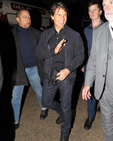 EXCLUSIVE: Tom Cruise leaves the Adele concert at BST Hyde Park and is mobbed by fans wishing him a happy 60th birthday. The actor, 59, is believed to have recently split from his Mission Impossible co-star Hayley Atwell, 40, who is now thought to be dating a music producer. The Top Gun legend cut a casual figure with slim jeans and a fitted black polo t-shirt which showed off his muscular physique, completing the look with a suede jacket and matching black face mask. His mystery brunette pal donned flared blue jeans, comfortable trainers and a pink Gucci cardigan. The pair were all smiles as they entered the concert grounds in Hyde Park, before Tom stopped to speak to fans and pose for selfies while his beaming friend hanged back and watched on. 02 Jul 2022 Pictured: Tom Cruise. Photo credit: MEGA TheMegaAgency.com +1 888 505 6342 (Mega Agency TagID: MEGA874102_003.jpg) [Photo via Mega Agency]