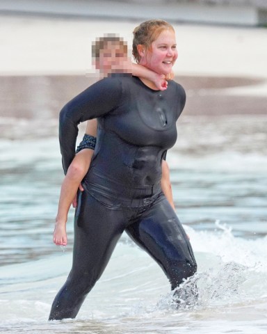 Amy Schumer with husband Chris Fischer and son Gene David Fischer having a fun day at the beach in Saint Barts, French West Indies on December 27, 2022. Photo by ABACAPRESS.COM**USE CHILD PIXELATED IMAGES IF YOUR TERRITORY REQUIRES IT**Pictured: Amy SchumerRef: SPL5511875 271222 NON-EXCLUSIVEPicture by: AbacaPress / SplashNews.comSplash News and PicturesUSA: +1 310-525-5808London: +44 (0)20 8126 1009Berlin: +49 175 3764 166photodesk@splashnews.comUnited Arab Emirates Rights, Australia Rights, Bahrain Rights, Canada Rights, Greece Rights, India Rights, Israel Rights, South Korea Rights, New Zealand Rights, Qatar Rights, Saudi Arabia Rights, Singapore Rights, Thailand Rights, Taiwan Rights, United Kingdom Rights, United States of America Rights