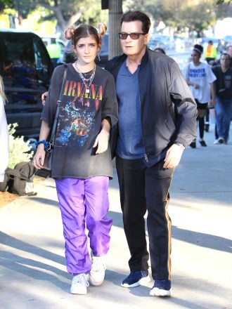 Charlie Sheen attended the Billie Eilish concert at The Greek Theater in Los Angeles with daughter Sam Sheen.  During the security checkpoint Charlie removed a clear container from his pockets containing colored tablets.  Charlie's daughter Sam wore a vintage Nirvana t-shirt for the outing.  11 Jul 2019 Pictured: Charlie Sheen shows the security clear container with colored tablets at the Billie Eilish concert.  Photo credit: ROMA / MEGA TheMegaAgency.com +1 888 505 6342 (Mega Agency TagID: MEGA464430_008.jpg) [Photo via Mega Agency]