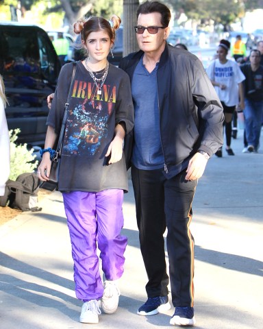 Charlie Sheen attended the Billie Eilish concert at The Greek Theater in Los Angeles with daughter Sam Sheen. During the security checkpoint Charlie removed a clear container from his pockets containing colored tablets. Charlie's daughter Sam wore a vintage Nirvana t-shirt for the outing. 11 Jul 2019 Pictured: Charlie Sheen shows the security clear container with colored tablets at the Billie Eilish concert. Photo credit: ROMA / MEGA TheMegaAgency.com +1 888 505 6342 (Mega Agency TagID: MEGA464430_008.jpg) [Photo via Mega Agency]