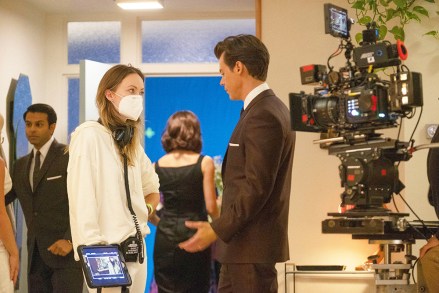DON'T WORRY DEAR, from left: director Olivia Wilde, Harry Styles, on set, 2022. ph: Merrick Morton /© Warner Bros.  / Courtesy Everett Collection