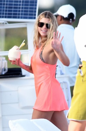 EXCLUSIVE: Sofia Richie wearing a bright neon dress over her bikini as she soaks up the sun on a Miami beach with Scott Disick. 26 Nov 2019 Pictured: Sofia Richie. Photo credit: MEGA TheMegaAgency.com +1 888 505 6342 (Mega Agency TagID: MEGA557178_001.jpg) [Photo via Mega Agency]