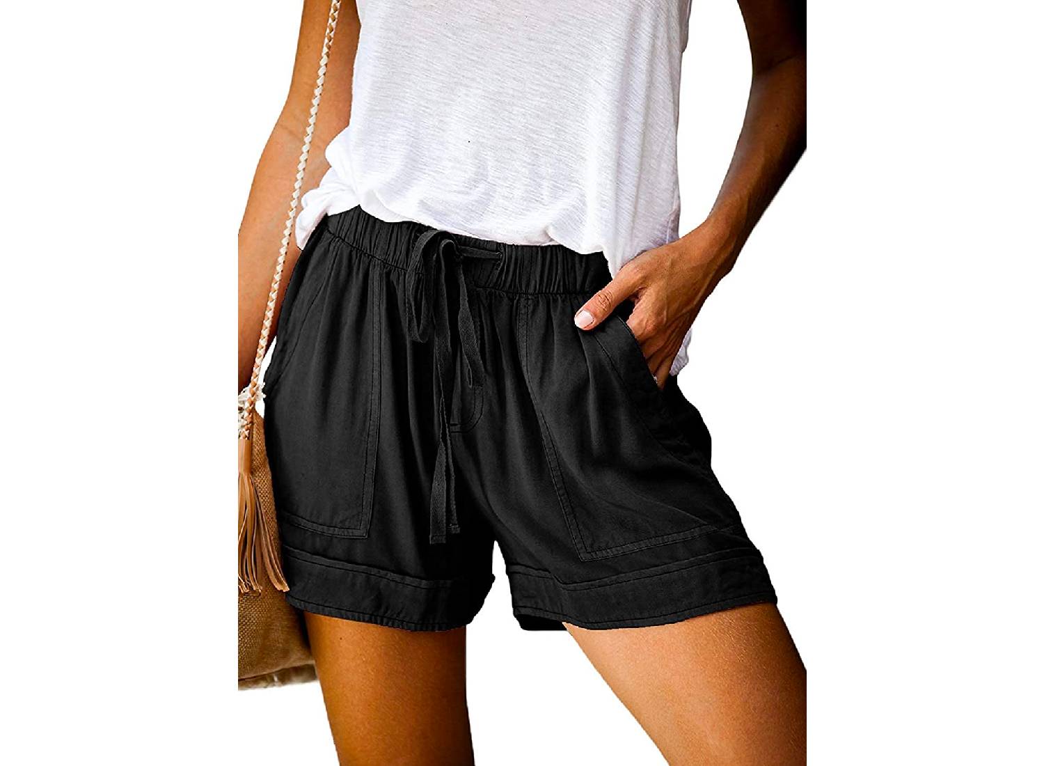 A woman wearing pair of flowy drawstring black shorts from Acelitt