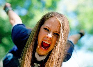 LAVIGNE Singer Avril Lavigne gestures during a photo session in New York's Central Park . A new crop of female singer-songwriters like Lavigne are challenging the notion that you have to bare your navel and cavort around in tight clothes to be sexy. Over the last year, artists like Pink, Michelle Branch, Vanessa Carlton and Lavigne have been dominating the charts with by putting the focus on their music, and not their looksMUSIC AVRIL LAVIGNE, NEW YORK, USA