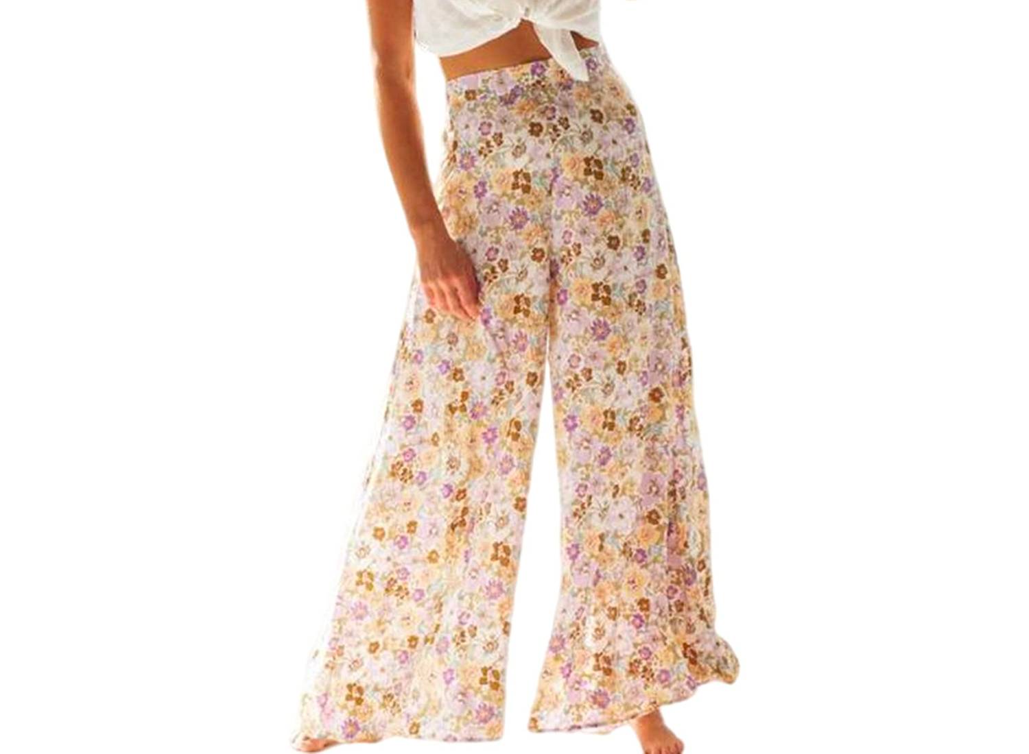 Woman wearing multicolored floral boho pants that are high-waisted and wide-leg