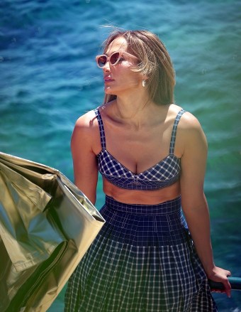 CAPRI, Italy - *EXCLUSIVE* - Recently married Jennifer Affleck (Lopez) oozes glamour as she posed in the Italian sun at a photoshoot.  Jennifer married her actor beau Ben Affleck in an intimate ceremony in Las Vegas and here we see the 53-year-old defying her age at her sexy shoot, flaunting her eye-catching figure in a blue gingham patterned dress. Keep on flaunting!  ** Shot 08/01/2022 ** Image: Jennifer Lopez - J-Lo - Jennifer Affleck Backgrid USA 4 August 2022 USA: +1 310 798 9111 / usasales@backgrid.comUK: +44 208 344 2007 / uksales@ backgrid.  com*UK Clients - Children's Images Please pixelate faces before publication*