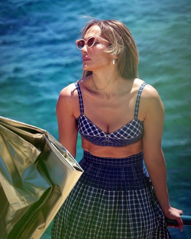 Capri, ITALY - *EXCLUSIVE* - Recently Married Jennifer Affleck (Lopez) oozes glamour while pictured in the Italian sunshine on a photoshoot.Jennifer married her actor beau Ben Affleck in an intimate ceremony out in Las Vegas and here we see the 53-year-old continue to defy her age in her sexy shoot flaunting her voluptuous alluring figure in a blue gingham patterned dress! **SHOT ON 08/01/2022**Pictured: Jennifer Lopez - J-Lo - Jennifer AffleckBACKGRID USA 4 AUGUST 2022 USA: +1 310 798 9111 / usasales@backgrid.comUK: +44 208 344 2007 / uksales@backgrid.com*UK Clients - Pictures Containing ChildrenPlease Pixelate Face Prior To Publication*