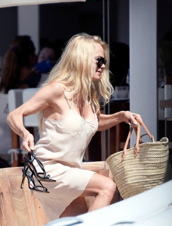 EXCLUSIVE: Pamela Anderson is spotted enjoying a sun-soaked St Barths vacation with a handsome mystery man. The 55-year-old former Baywatch star, who recently released her memoir 'Love, Pamela', was seen leaving the Caribbean island's famous Nikki Beach restaurant with her younger son Dylan Lee, 25. Her tall, dark lunch companion looked ultra cool and casual in sunglasses with a tropical print open necked shirt, sporting a stubble and longer hairdo. Pamela looked chic in a white slip dress, wearing her famous blonde locks loose over her shoulders. It is not known if the two are linked romantically but they have been holed up together in an ultra-exclusive, secluded villa for over a week. A new Netflix documentary covers Anderson's colorful love life, from her marriage to Tommy Lee, to her on/off romance with surfer Kelly Slater, and her most recent divorce from bodyguard Dan Hayhurst last year. She has walked down the aisle five times. The new documentary lets fans into her life from her humble beginnings to her rise to fame and the infamous sex tape with then-husband Tommy Lee, which was stolen from their home. In February 1995, Anderson and Mötley Crüe drummer Lee eloped after just 96 hours of knowing one another. They welcomed their first child Brandon in June 1996, and a year later in December 1997, their second son Dylan was born. The pair eventually split in 1998, after the musician was arrested and sentenced to six months in jail for spousal battery after assaulting his wife. 03 Apr 2023 Pictured: Pamela Anderson. Photo credit: Spread Pictures/MEGA TheMegaAgency.com +1 888 505 6342 (Mega Agency TagID: MEGA965156_001.jpg) [Photo via Mega Agency]