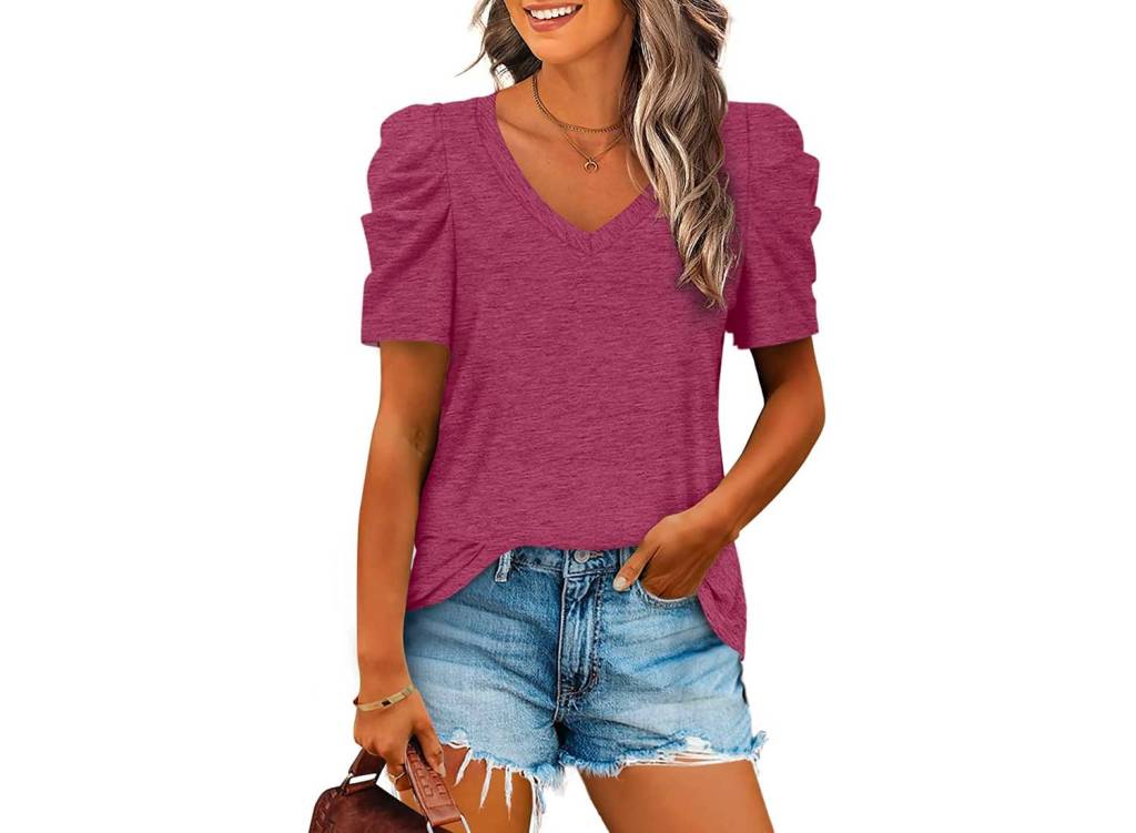 A woman wearing a maroon XIEERDUO v-neck puff sleeve top with jean shorts