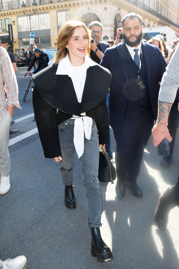 Emma Watson looks Italian-chic in a black skirt and white blouse as she  arrives at the Palazzo Parigi hotel with her dog during Milan Fashion Week