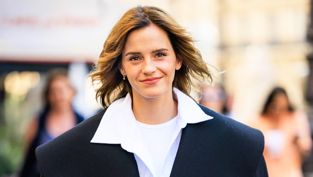 Emma Watson looks Italian-chic in a black skirt and white blouse as she  arrives at the Palazzo Parigi hotel with her dog during Milan Fashion Week