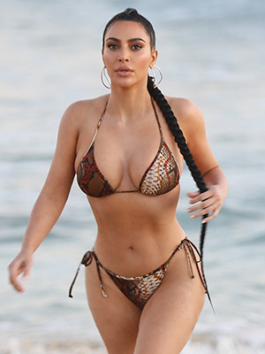 Kim Kardashian's skin is painted gold as she sports a sexy SKIMS