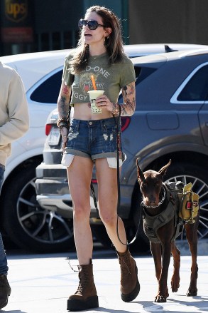 EXCLUSIVE: Paris Jackson shows off her legs and midriff in a pair of denim cut-off short shorts and an Iggy Pop T-shirt while training her Doberman Pincher service dog with a mystery guy in L.A. on Saturday. Paris and the mystery guy took the dog to a K9 service animal training facility before grabbing a couple of Boba drinks to-go. This was the first time Paris has been photographed since the online backlash for posing on a red carpet in a nude dress. 29 Apr 2023 Pictured: Paris Jackson. Photo credit: Garrett Press/ MEGA TheMegaAgency.com +1 888 505 6342 (Mega Agency TagID: MEGA974667_004.jpg) [Photo via Mega Agency]
