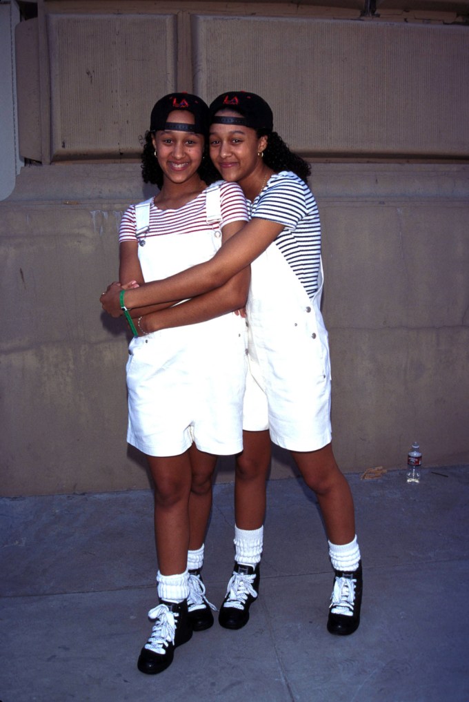 Tia Mowry and Tamera Mowry pose together in 1995