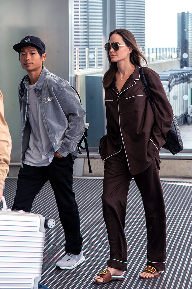 Angelina Jolie in a Chic Long Black Overcoat and Carrying a Dior