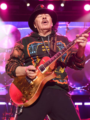 Musican Carlos Santana and his wife, Deborah, poses for