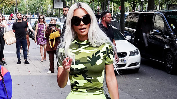 kim kardashian looks striking in a camo top and neon green leggings while  out shopping at balenciaga in paris, france-050722_12