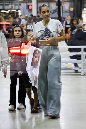 Los Angeles, CA - *EXCLUSIVE* - Doting Mother Kim Kardashian proves to be 'Mom Goals' as she goes all out showing support for her daughter North's basketball game in Los Angeles.  Kim is seen arriving with her son Saint and niece Penelope while holding a huge poster with multiple pictures of North.  Pictured: Kim Kardashian BACKGRID USA 6 JANUARY 2023 USA: +1 310 798 9111 / usasales@backgrid.com UK: +44 208 344 2007 / uksales@backgrid.com *UK Clients - Pictures Containing Children Please Pixelate Face Prior To Publication*
