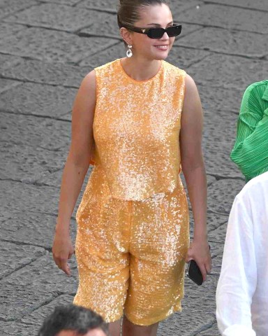 Capri, ITALY  - *EXCLUSIVE*  - American Singer Selena Gomez takes a stroll through town as she browses the shops during her holidays in Capri, Italy.  Selena out with her sequinned dress was seen with friends popping into the Prada designer store, as a rather smart-looking Italian–Canadian film producer Andrea Iervolino in his suit jacket joined Selena on the shopping spree. *Shot on August 3, 2022*  Pictured: Selena Gomez  BACKGRID USA 5 AUGUST 2022   BYLINE MUST READ: Cobra Team / BACKGRID  USA: +1 310 798 9111 / usasales@backgrid.com  UK: +44 208 344 2007 / uksales@backgrid.com  *UK Clients - Pictures Containing Children Please Pixelate Face Prior To Publication*