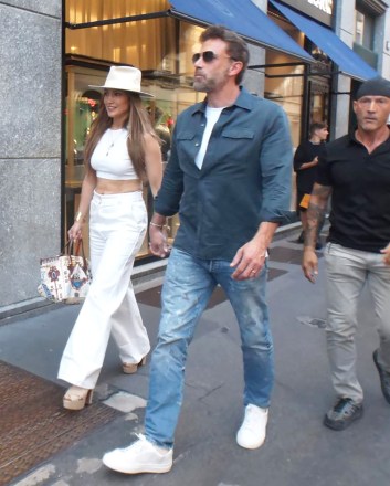 Surprisingly, in the late afternoon, Jennifer Lopez and her husband Ben Affleck arrive at the mall to do some shopping.  With some bodyguards making room among the people walking a short distance, then visiting some shops, word of their presence spreads and the crowd becomes large waiting for them outside Brunello Cucinelli, so the bodyguards bring a car right next door to a boutique, and so hardly Jennifer and Ben Affleck manage to Get entrance to leave immediately.  Jennifer Lopez and Ben Affleck arrive by surprise at Brunello Cucinelli, Milan, Italy - August 25, 2022